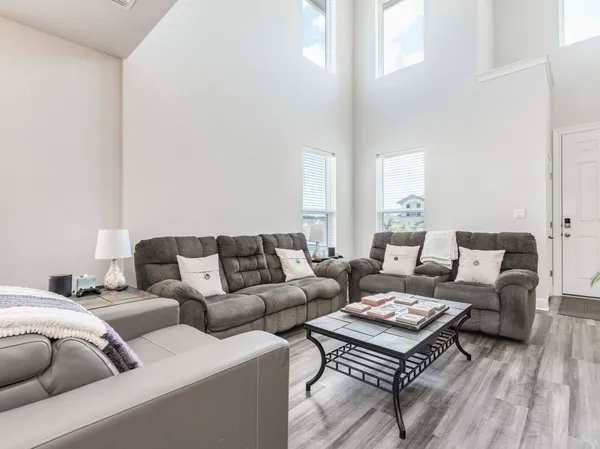 a living room with furniture a rug and a window