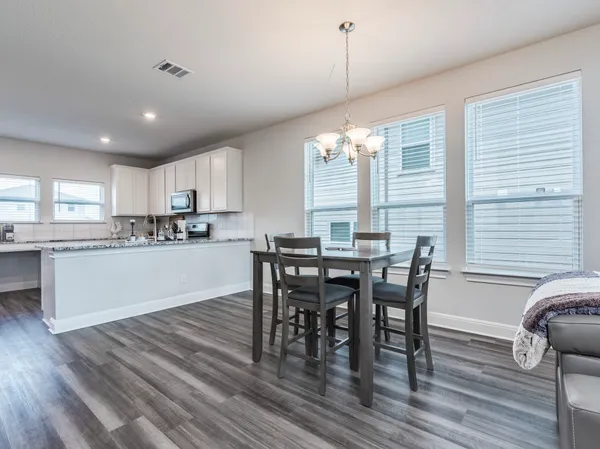a living room with furniture and kitchen view