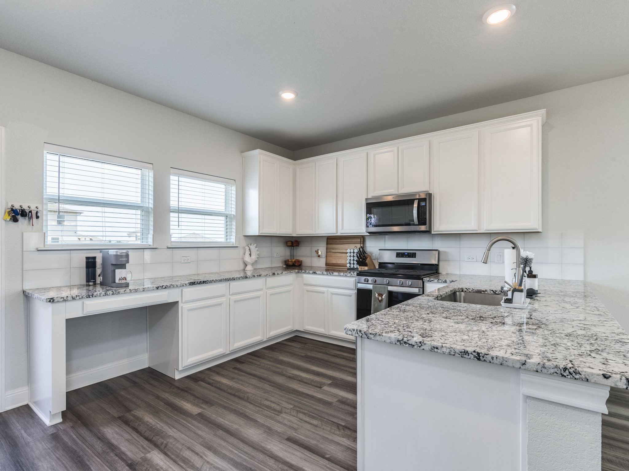 142 Mount Locke Road Dripping Springs, TX 78620 - Photo 8 of 31 a kitchen with a sink stove cabinets and refrigerator