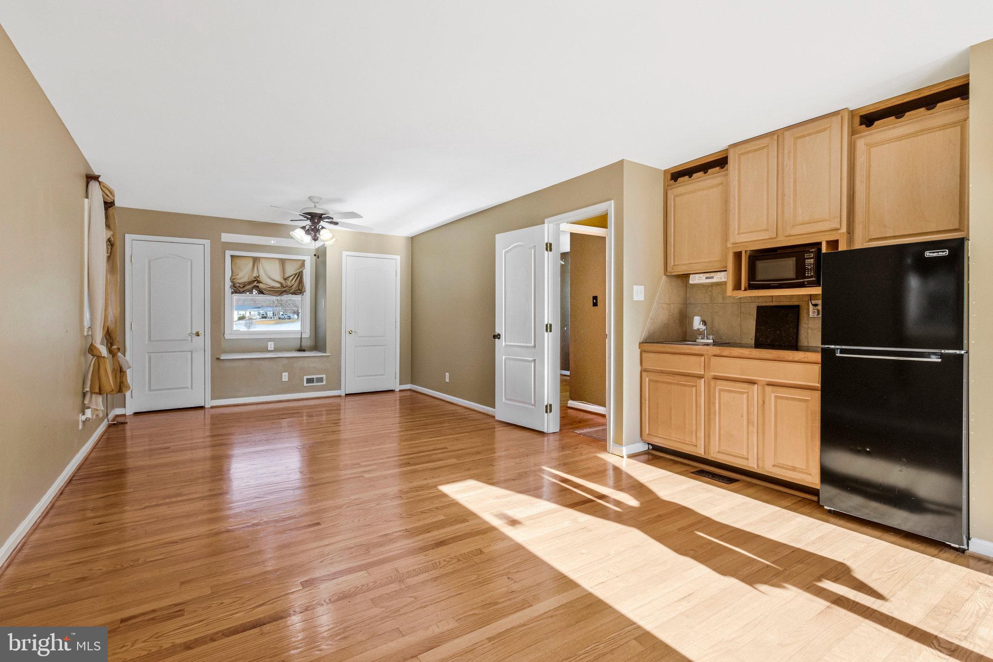 15295 Woodville Road Waldorf, MD 20601 - Photo 12 of 32 a kitchen with granite countertop a refrigerator and a stove top oven