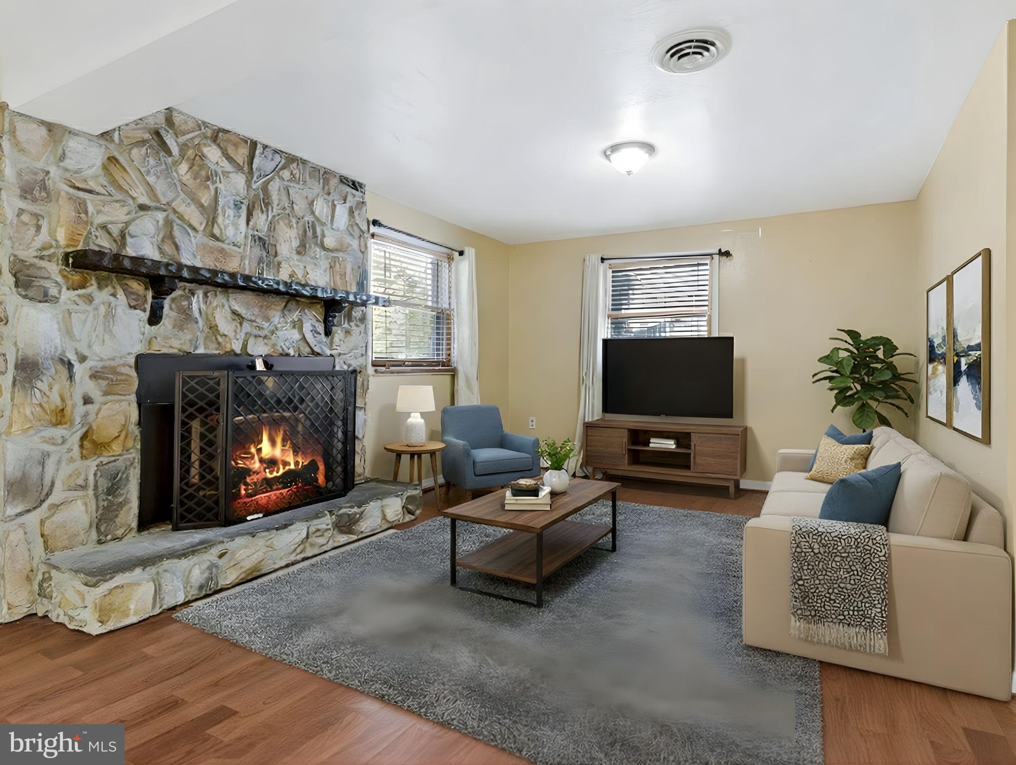 15295 Woodville Road Waldorf, MD 20601 - Photo 18 of 32 a living room with furniture a flat screen tv and a fireplace
