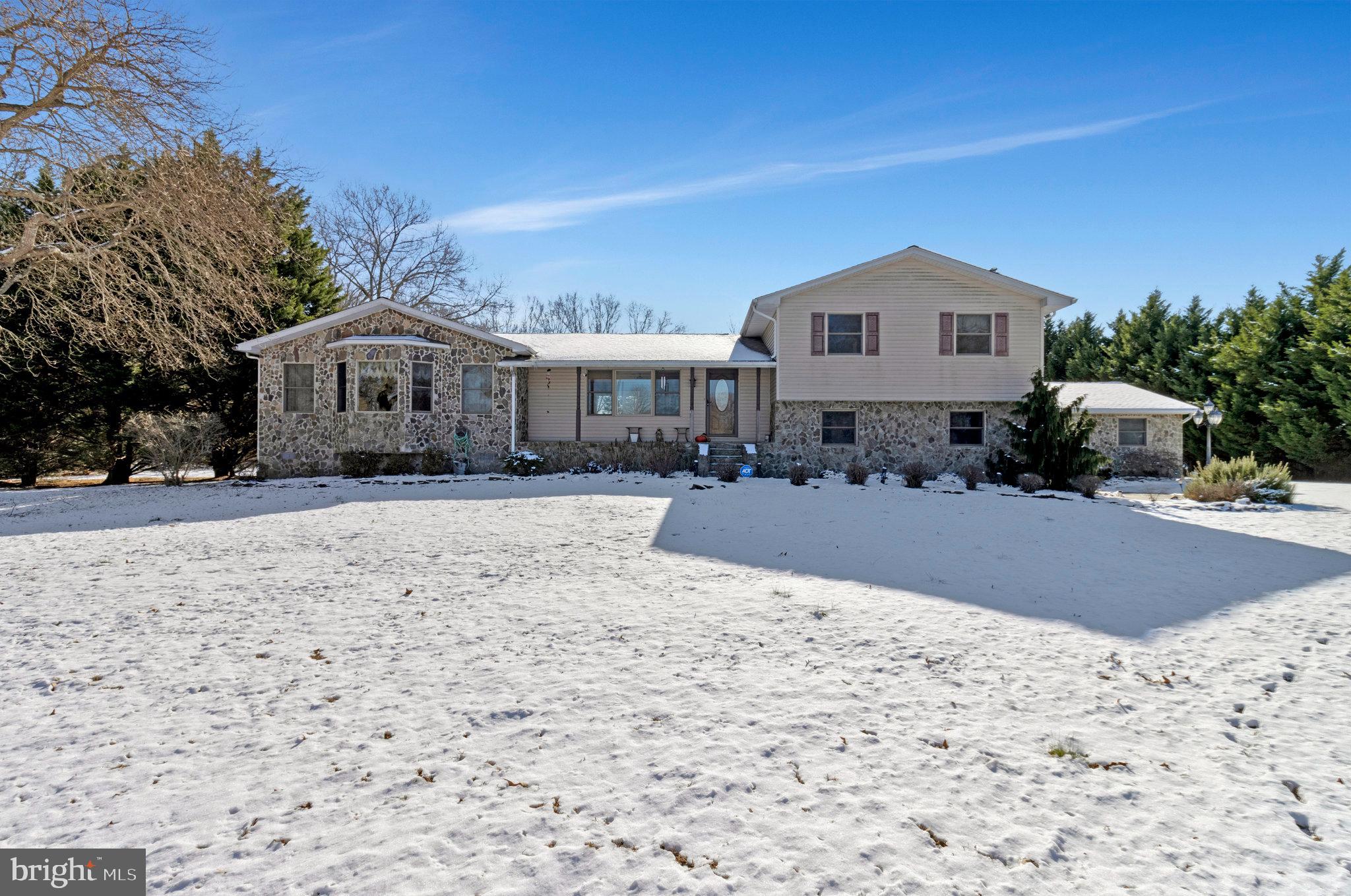 15295 Woodville Road Waldorf, MD 20601 - Photo 6 of 32 a front view of a house with a yard covered with snow