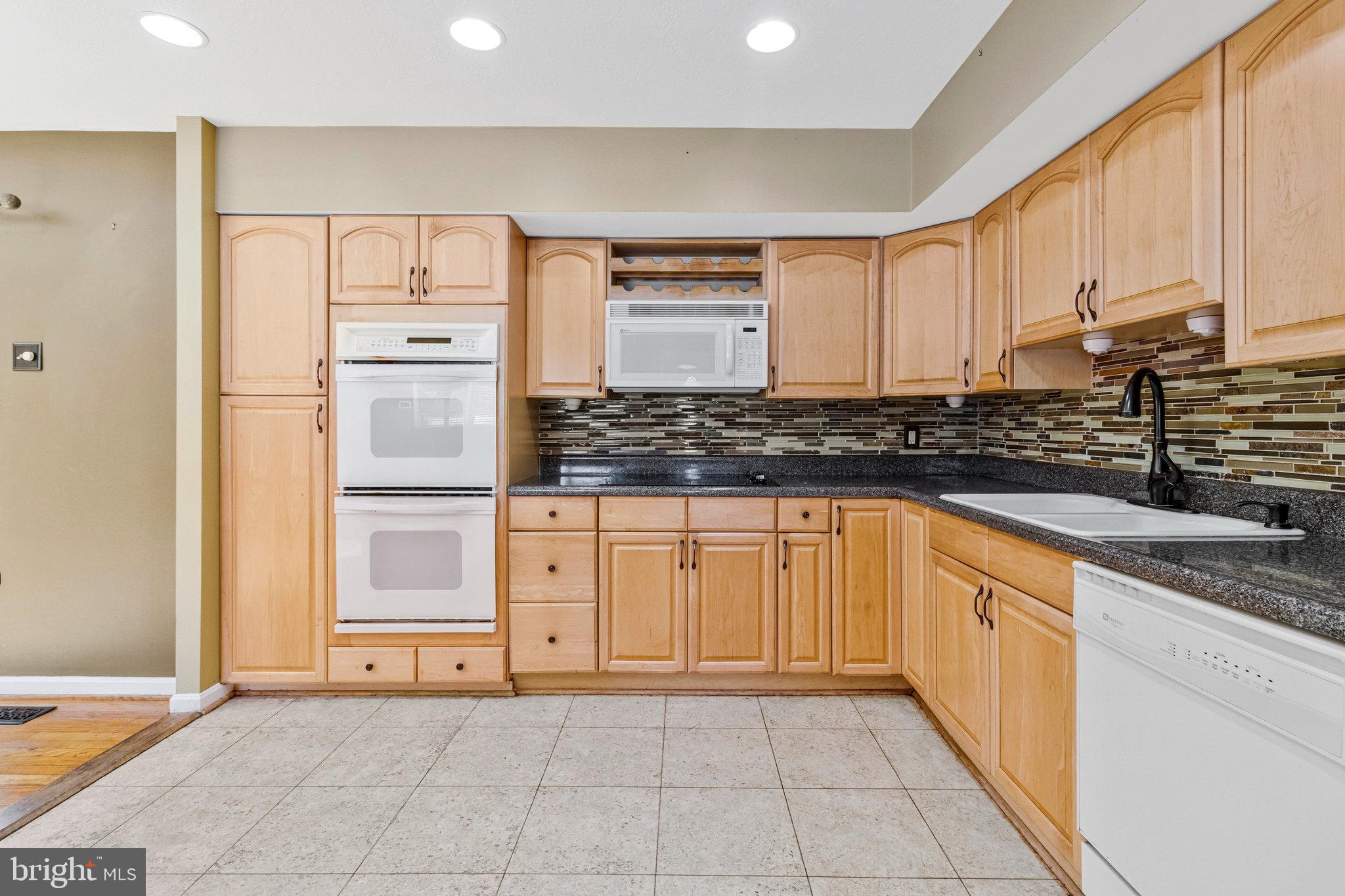 15295 Woodville Road Waldorf, MD 20601 - Photo 9 of 32 a kitchen with stainless steel appliances granite countertop a sink and cabinets