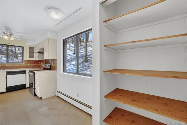a kitchen with white cabinets and appliances