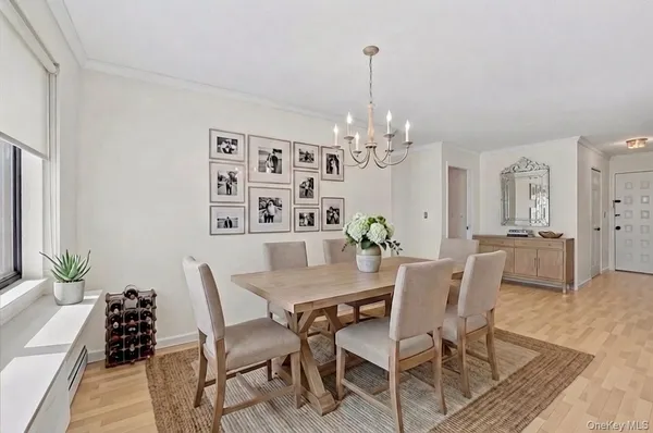 a view of a dining room with furniture and chandelier