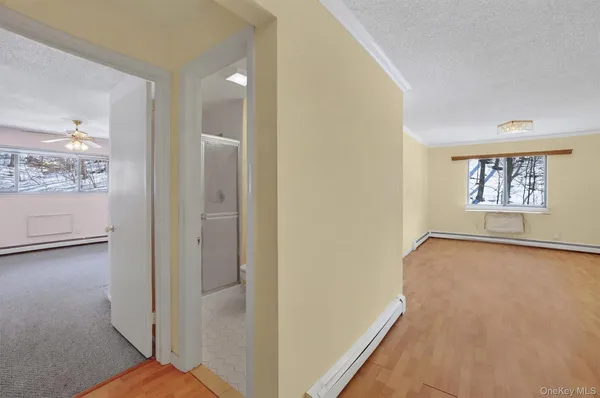 a view of a hallway with closet and window