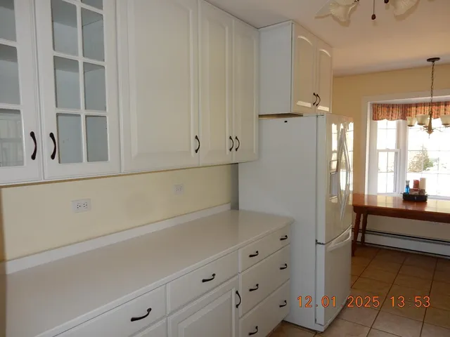 a kitchen with cabinets and window