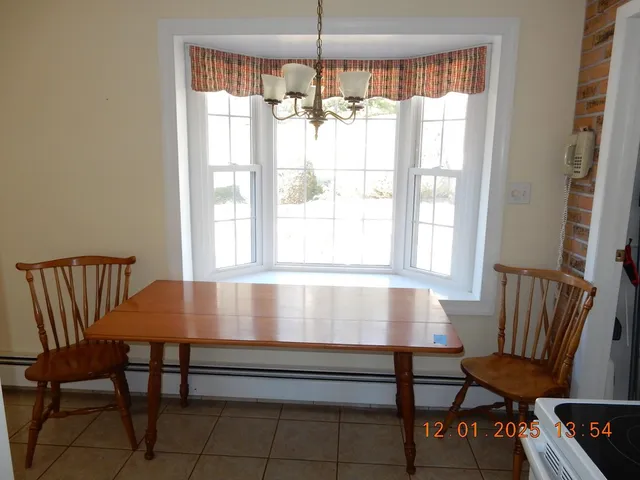 a view of a room with furniture and a window