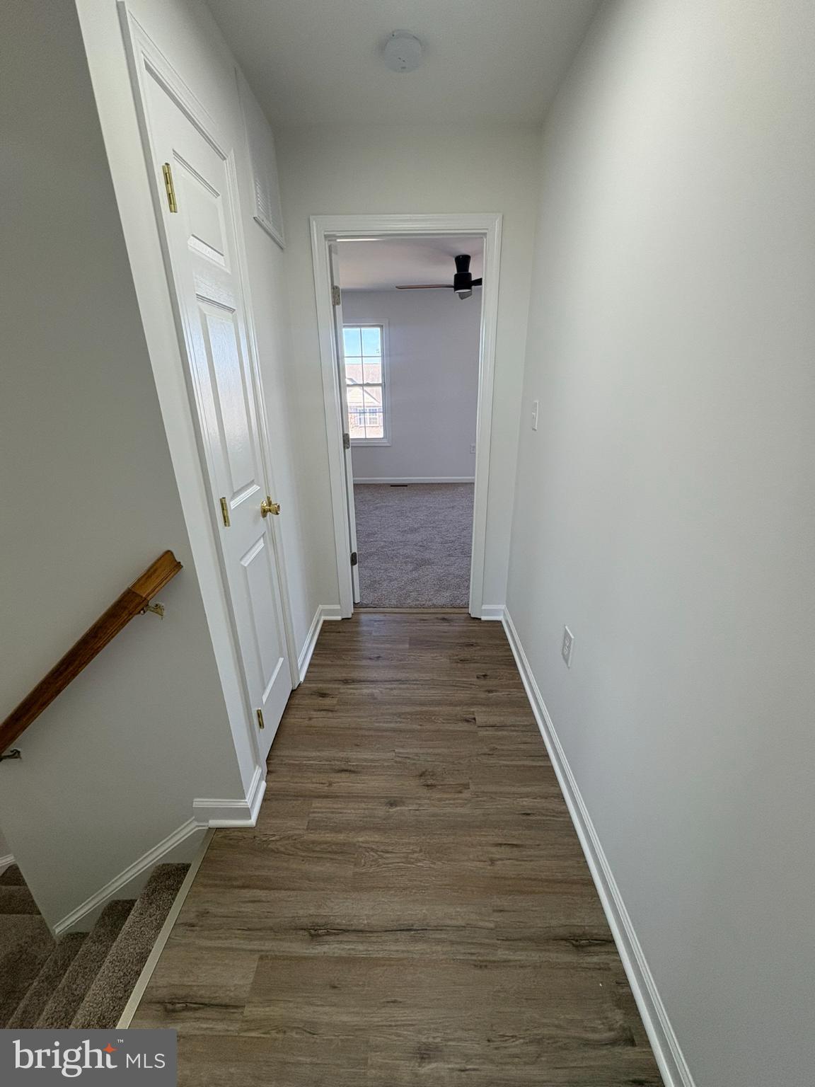 55 Fuzzy Tail Drive Ranson, WV 25438 - Photo 14 of 20 a view of a hallway with wooden floor and staircase