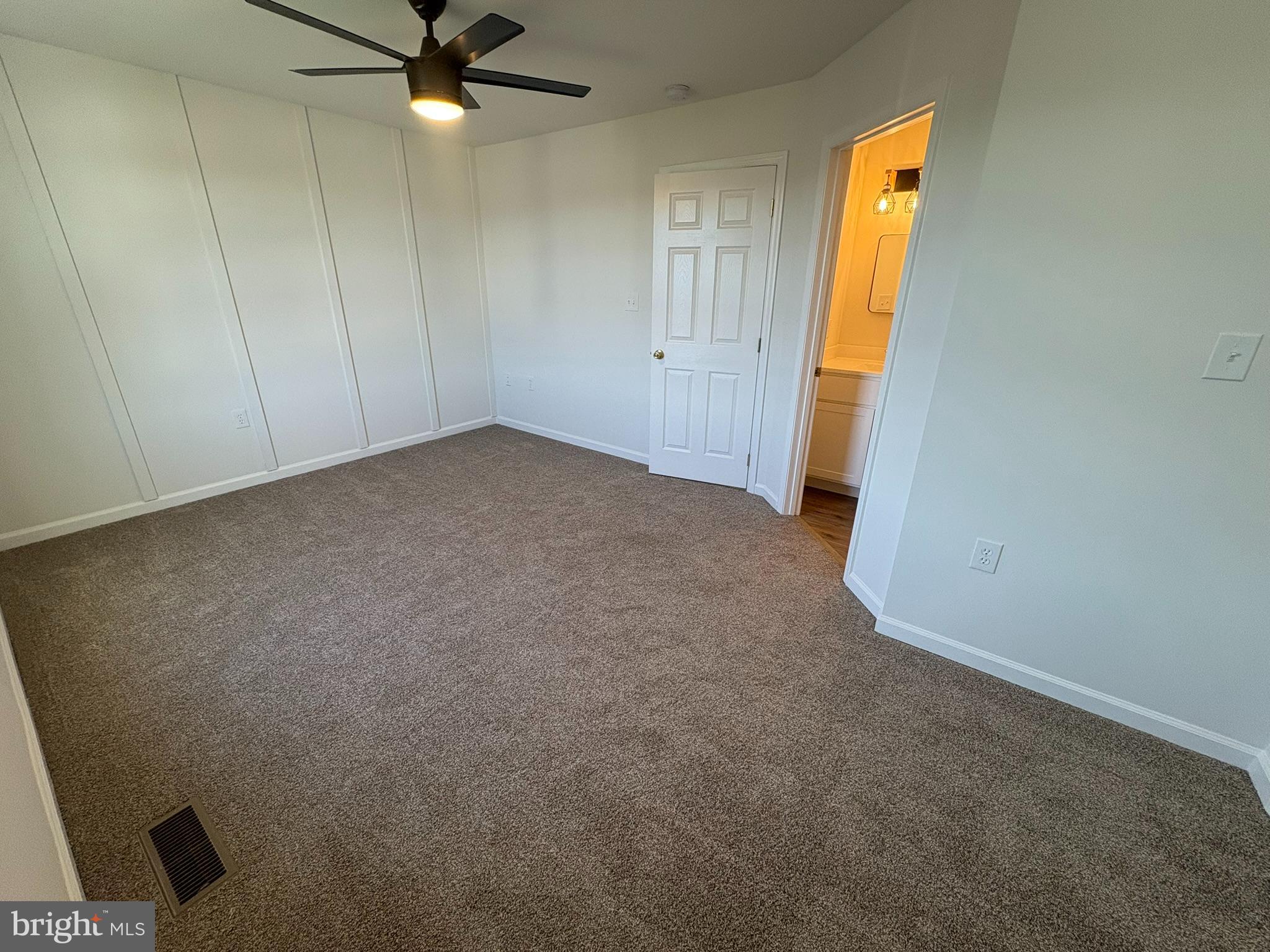55 Fuzzy Tail Drive Ranson, WV 25438 - Photo 18 of 20 an empty room with a ceiling fan and carpet