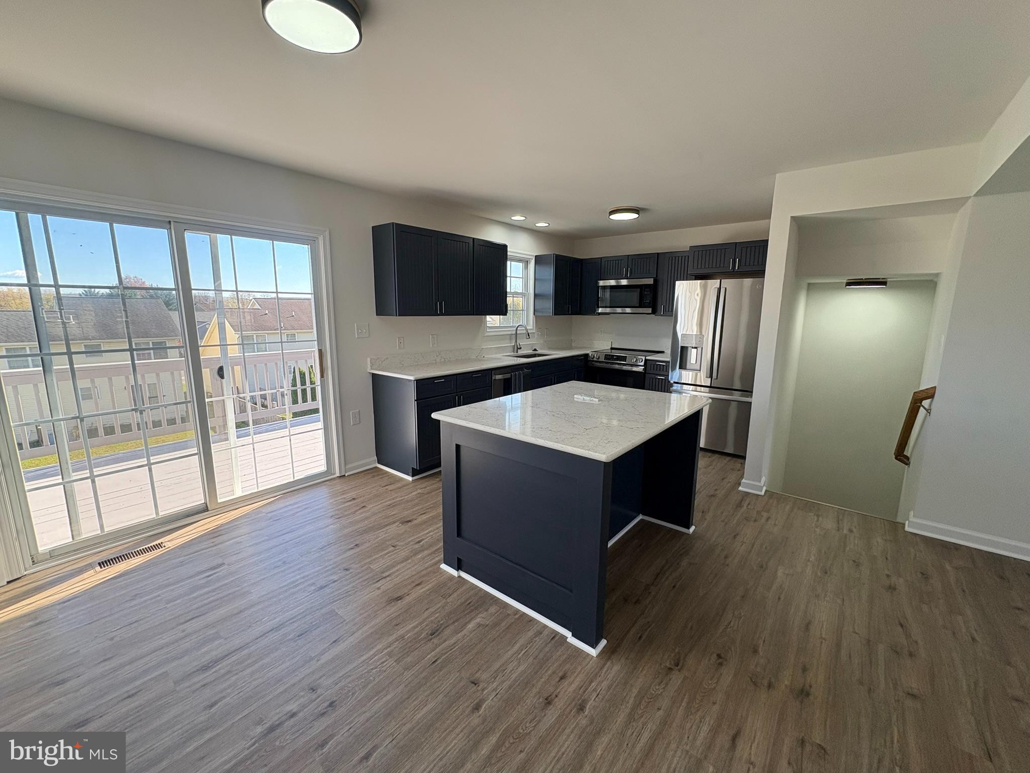 55 Fuzzy Tail Drive Ranson, WV 25438 - Photo 2 of 20 a kitchen with kitchen island a sink appliances and cabinets