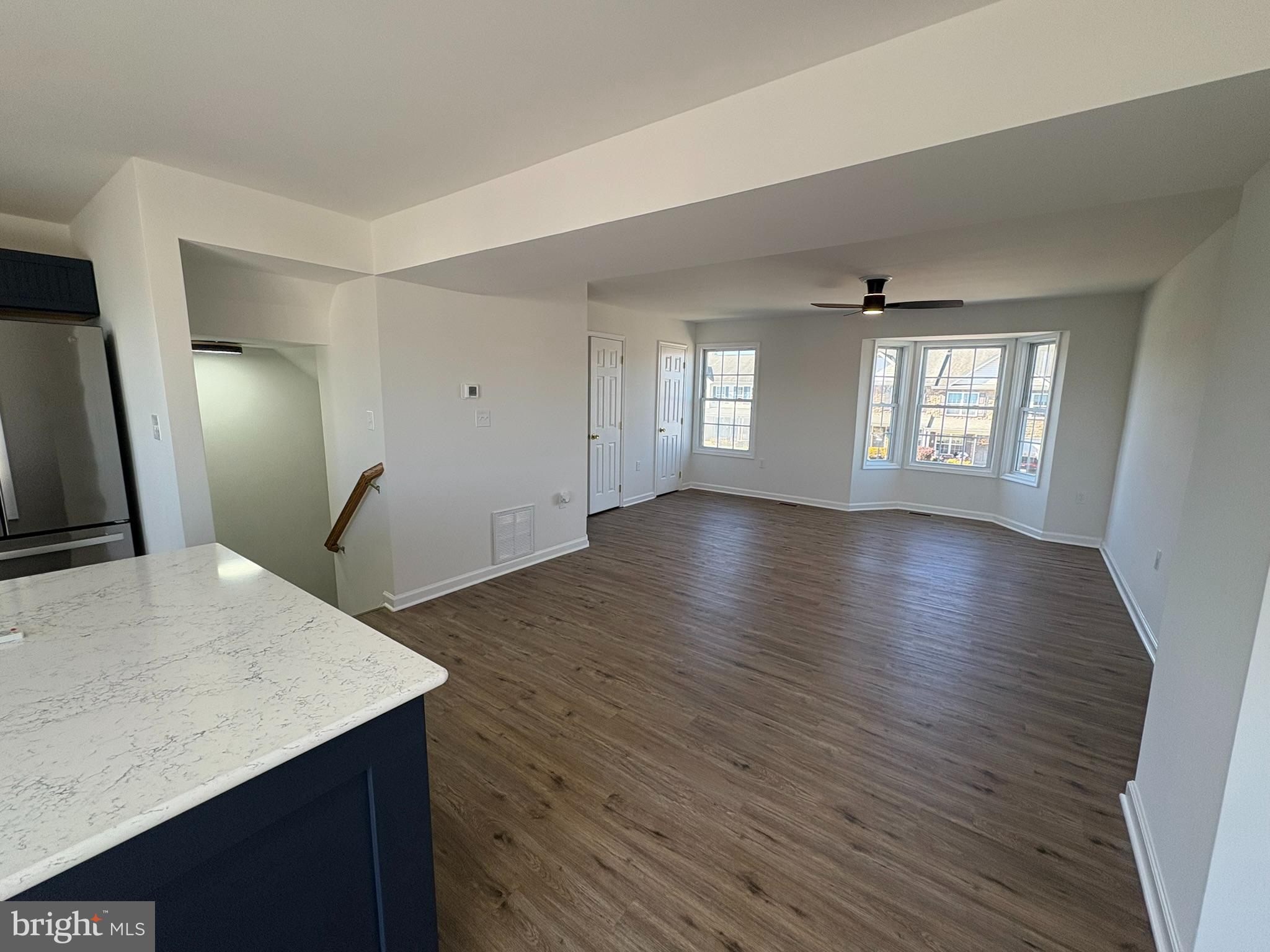 55 Fuzzy Tail Drive Ranson, WV 25438 - Photo 8 of 20 an empty room with wooden floor and windows