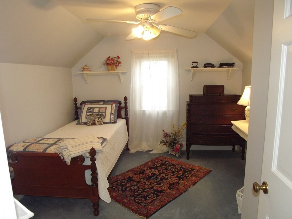 33 Fiske Hill Road Sturbridge, MA 01566 - Photo 25 of 29 a bedroom with a bed and a chandelier