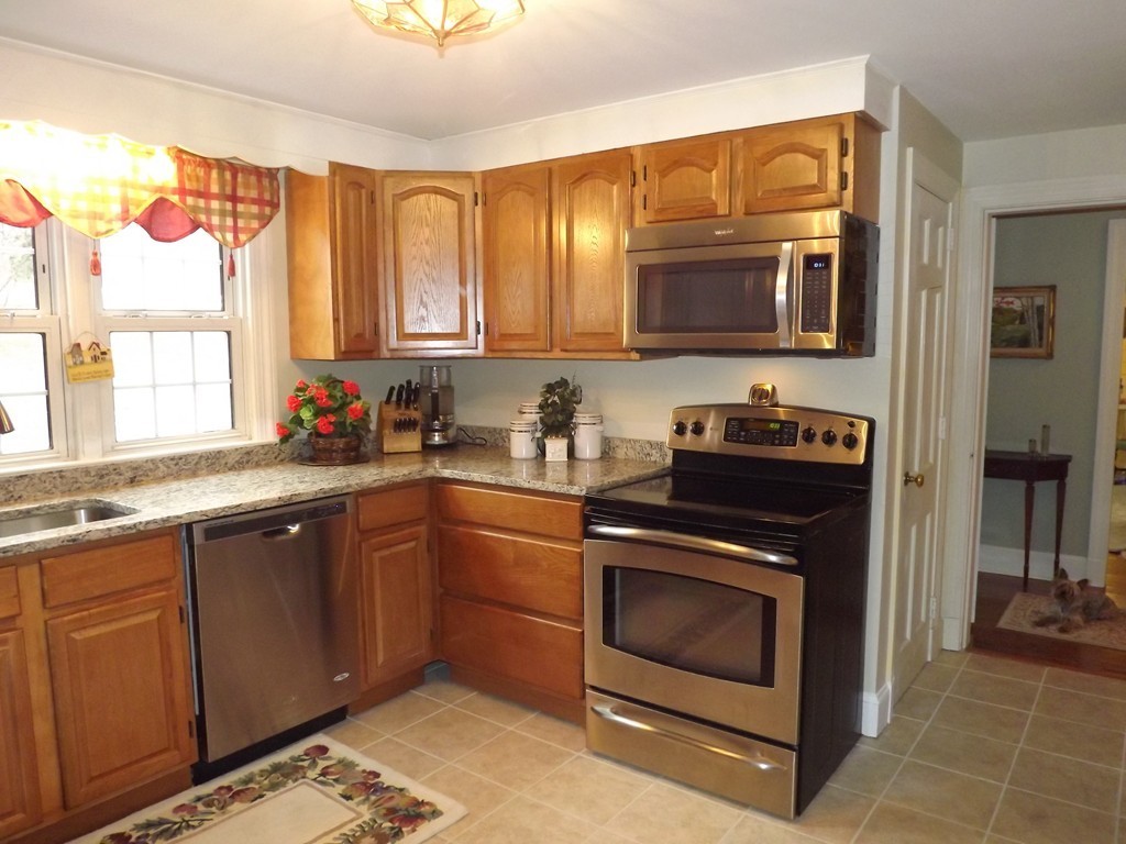 33 Fiske Hill Road Sturbridge, MA 01566 - Photo 4 of 29 a kitchen with stainless steel appliances granite countertop a stove a sink and a microwave