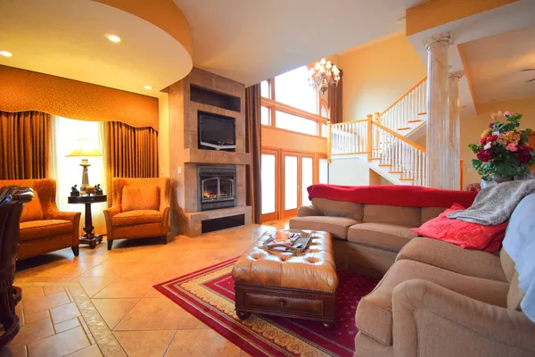 a living room with furniture a rug and a ceiling fan