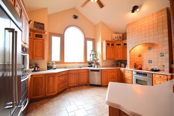 a large kitchen with stainless steel appliances lots of counter top space