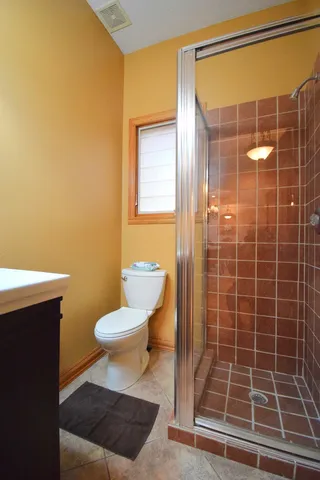 a bedroom with a bed and ceiling fan