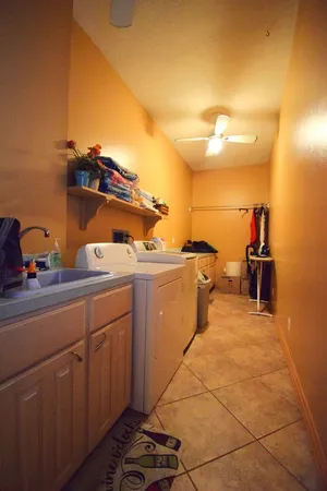 a view of a walk in closet and a bathroom