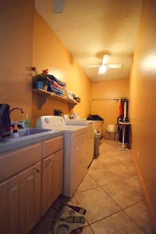 a view of a walk in closet and a bathroom