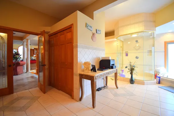 a large bathroom with a sink a toilet and a mirror