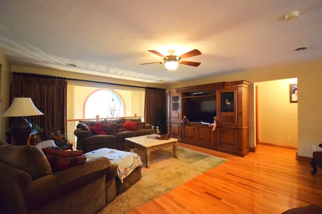 a living room with furniture a rug and a window