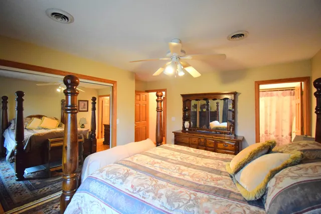 a bedroom with a large bed and a chandelier