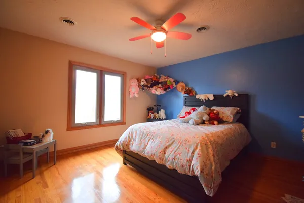 a bathroom with a sink a toilet a mirror and shower