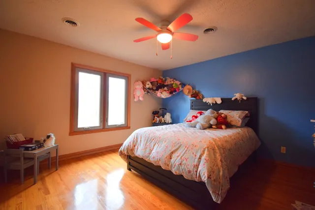 a bathroom with a sink a toilet a mirror and shower