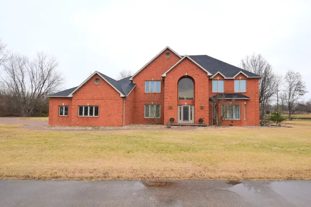 a view of a house with a yard and garage