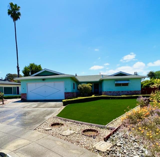 a view of a patio with a table and chairs under an umbrella