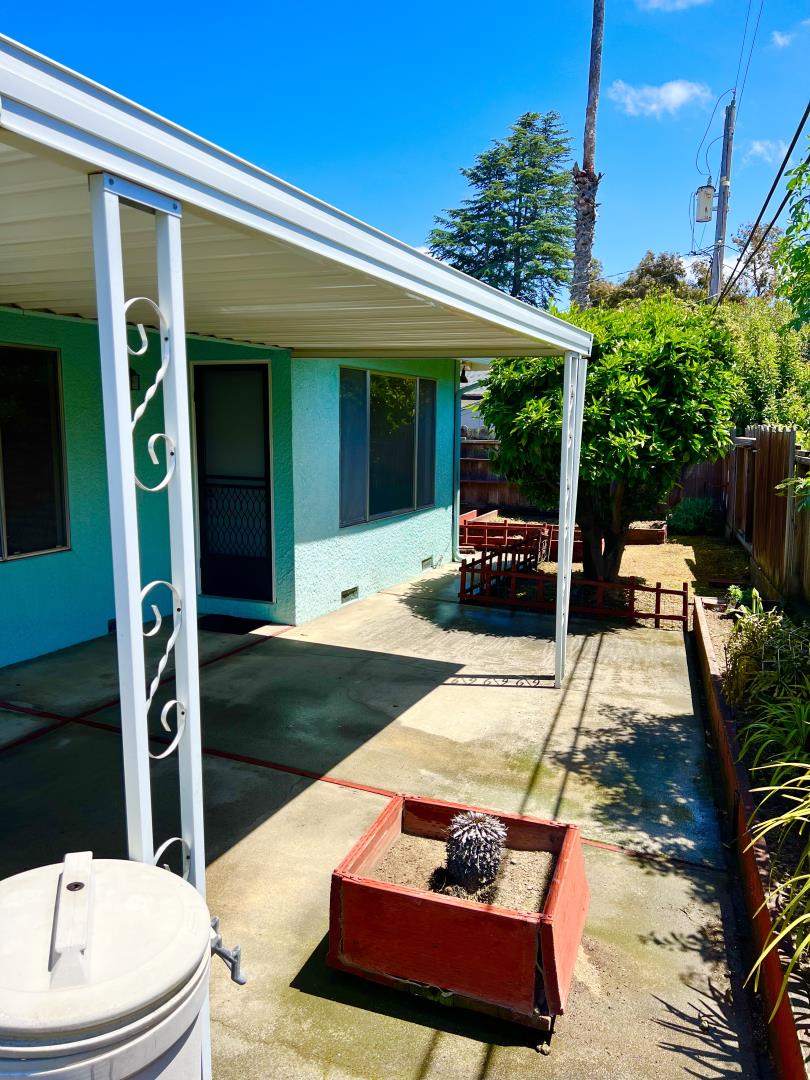 696 McCarty Avenue Mountain View, CA 94041 - Photo 30 of 31 a view of a patio with table and chairs potted plants and floor to ceiling window