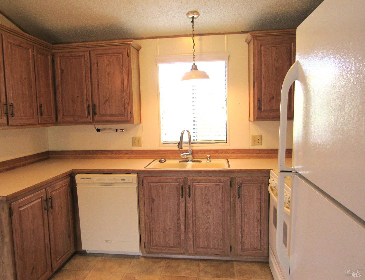 31 Ramon Street Sonoma, CA 95476 - Photo 17 of 24 a kitchen with stainless steel appliances granite countertop wooden cabinets a sink and a window