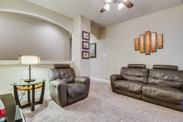 a living room with furniture a couch and a chandelier