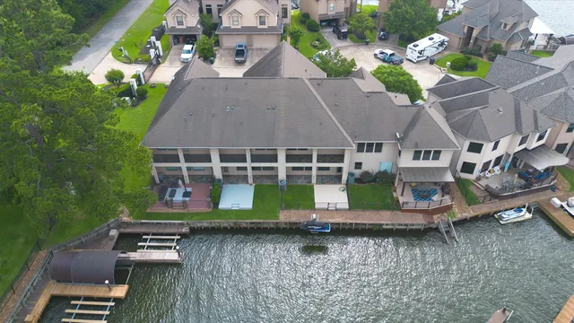 an aerial view of a house with roof deck outdoor seating and yard