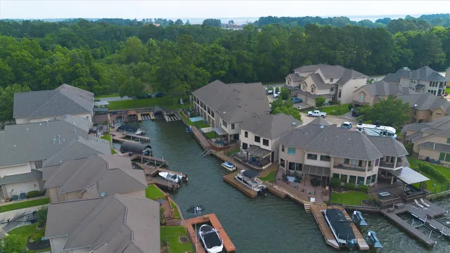 an aerial view of multiple houses with yard