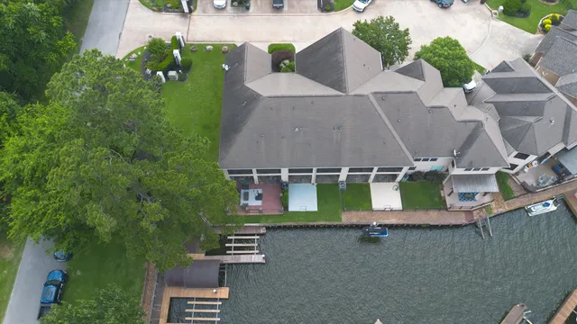an aerial view of a house with garden space and street view
