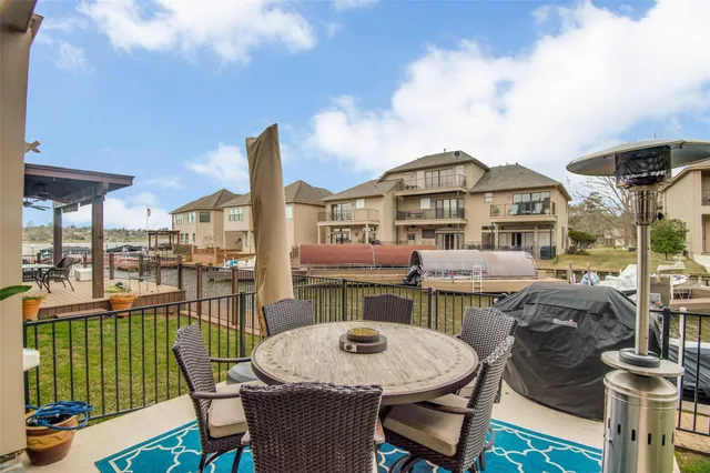 a balcony with table and chairs