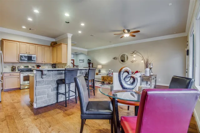 a kitchen with granite countertop a dining table and chairs