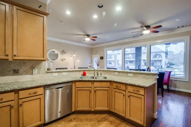 a kitchen with stainless steel appliances granite countertop a sink and cabinets