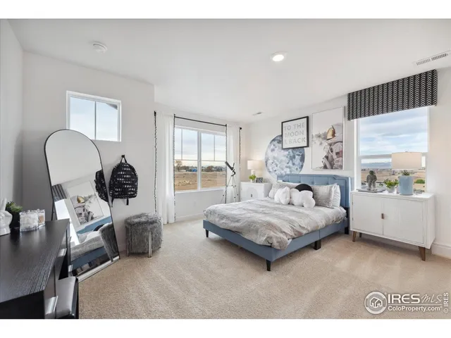 a bedroom with a bed window and couch