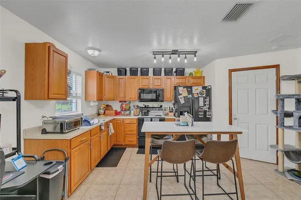 a view of a house with a big yard and large trees