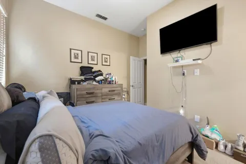 a bedroom with a bed and a flat screen tv