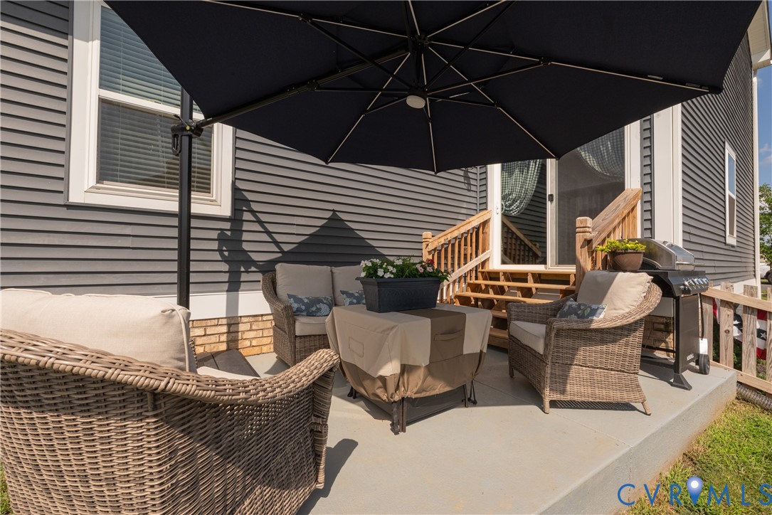 17854 Meriwether Lewis Street Ruther Glen, VA 22546 - Photo 35 of 39 Outdoor patio featuring concrete surfacing, a slid