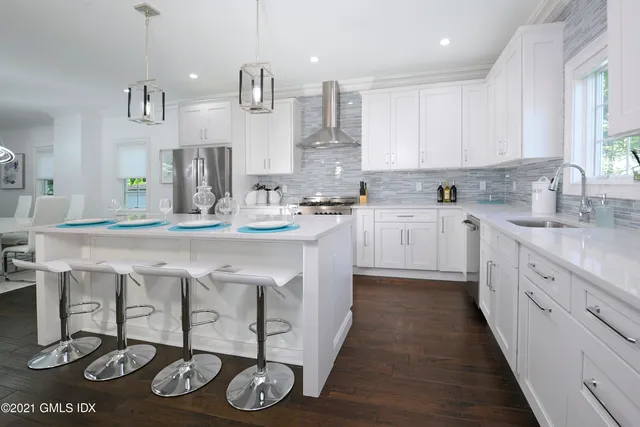 a kitchen with stainless steel appliances a sink stove and cabinets