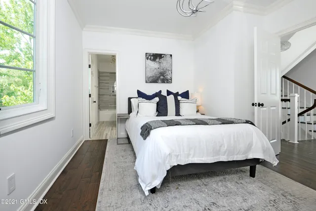 a bed sitting in a bedroom next to a window