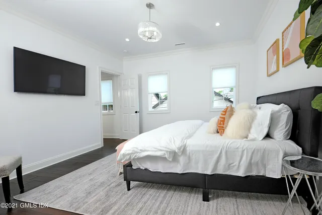 a bedroom with a bed and a flat screen tv