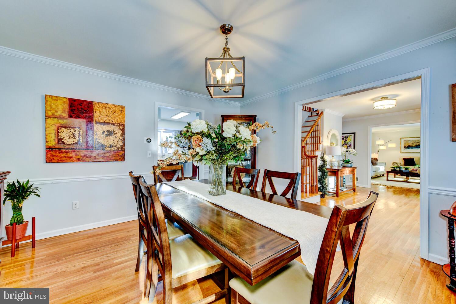 374 Village Road East Princeton Junction, NJ 08550 - Photo 18 of 54 a dining room with furniture potted plants and wooden floor