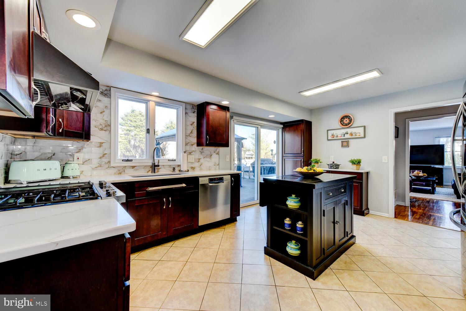 374 Village Road East Princeton Junction, NJ 08550 - Photo 19 of 54 a kitchen with stainless steel appliances granite countertop a stove a sink and a refrigerator