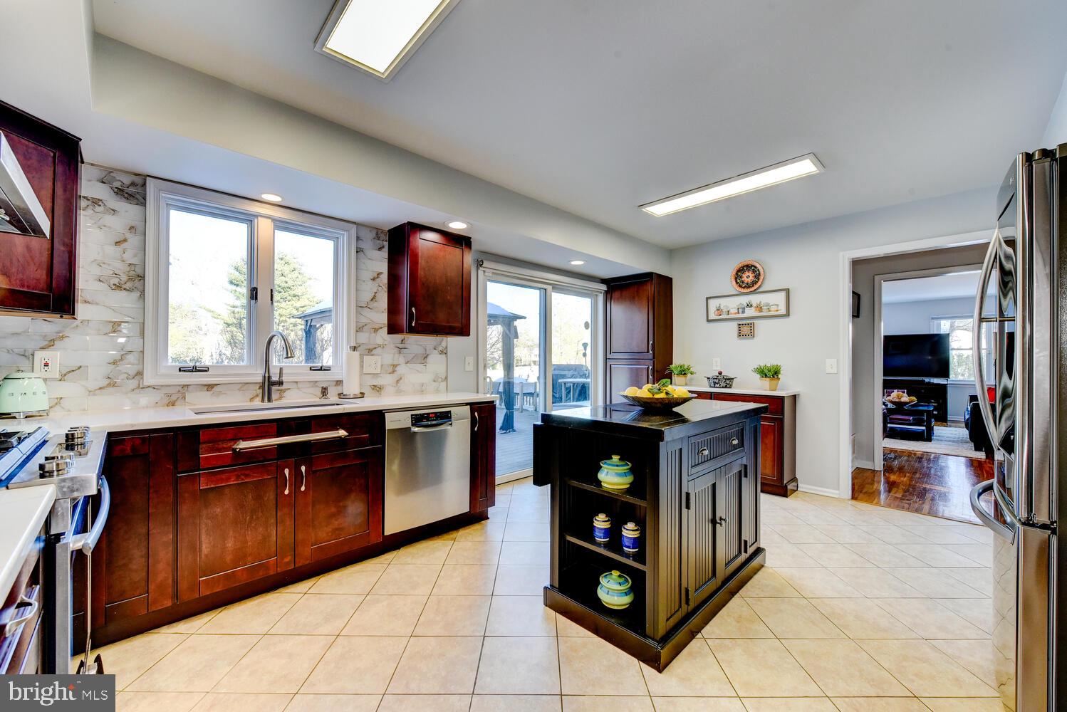 374 Village Road East Princeton Junction, NJ 08550 - Photo 20 of 54 a kitchen with stainless steel appliances granite countertop a stove a sink and a refrigerator