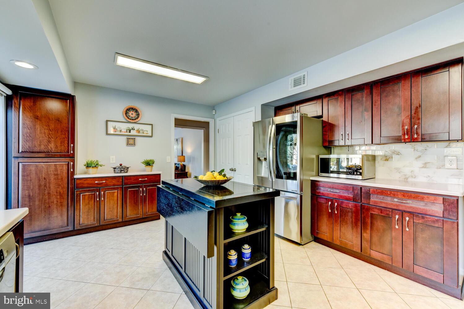 374 Village Road East Princeton Junction, NJ 08550 - Photo 22 of 54 a kitchen with stainless steel appliances granite countertop a stove refrigerator and cabinets